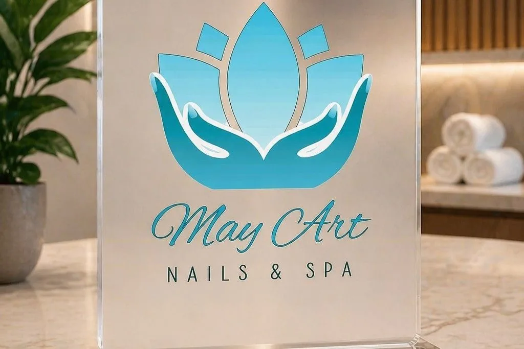 The turquoise lotus sign at the front desk, with rolled white towels and a plant