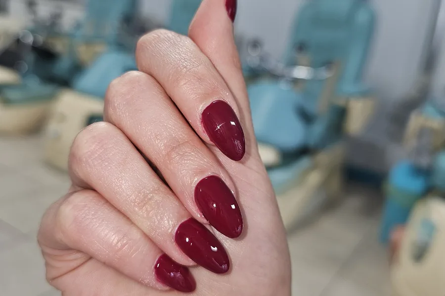 Burgundy gel nails photographed at the pedicure chair
