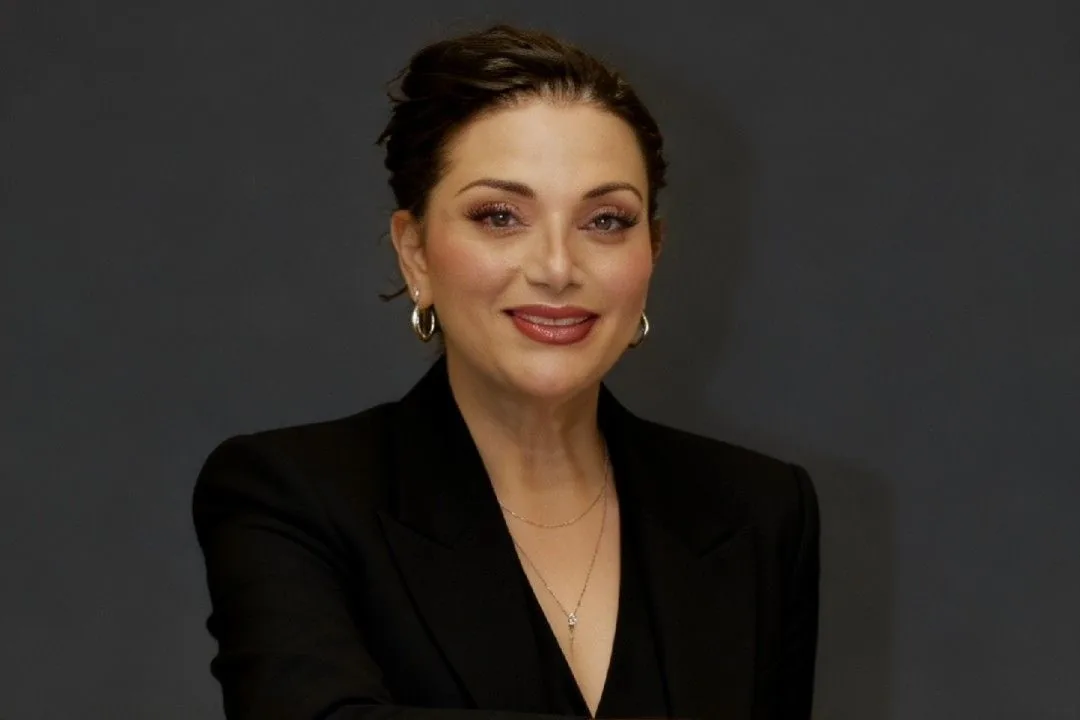 Mayerling — May — founder of May Art Nails & Spa, smiling in a black blazer