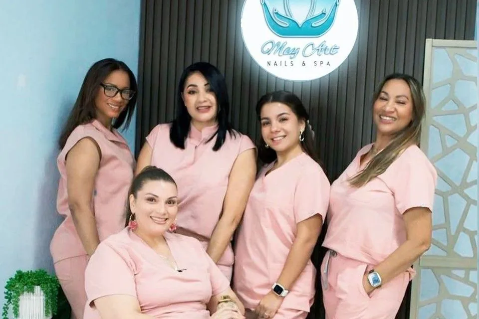 The May Art team — six women in pink scrubs under the lotus logo